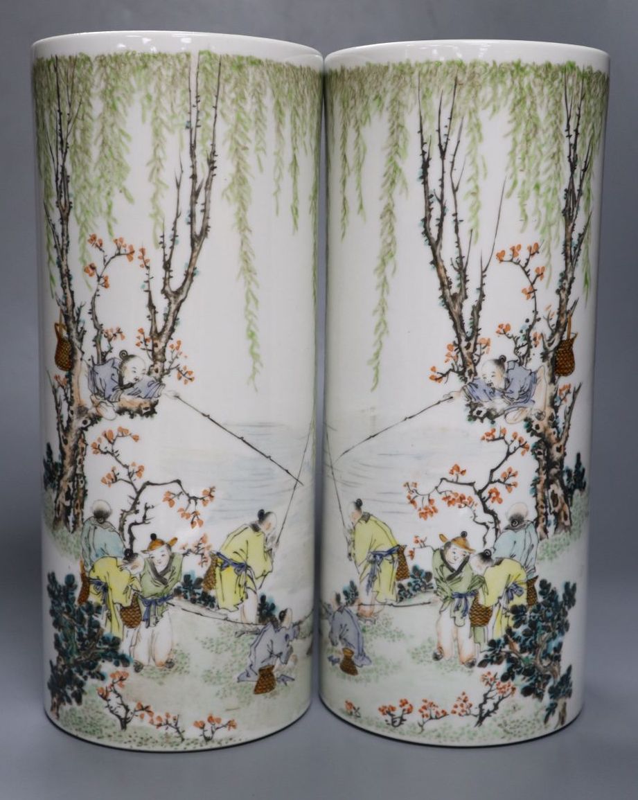 A pair of Chinese cylindrical porcelain vases, enamelled with fisherfolk, 29cm
